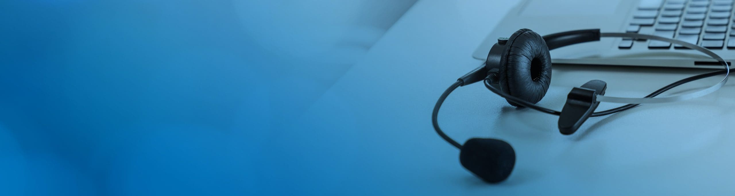 A headset laying on a desk.