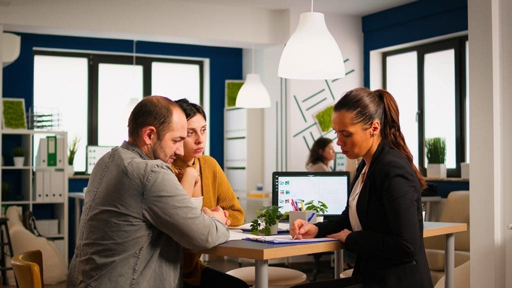 A business team collaborating with an IT consultant to discuss managed IT services solutions.